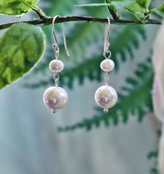 "MY GEMS ROCK Drop Length:1.5\"L. Description: A large and small white fresh water pearl wired together and hung on a sterling silver earring hook -Beautiful freshwater pearl earrings are an elegant and stunning accessory for any special occasion. -Hypo-allergenic rubber backing. https://www.etsy.com/shop/MYGEMSROCK" Hypoallergenic Pearl White Dangle Pearl Earrings, Hypoallergenic Pearl White Dangle Earrings, White Teardrop Pearl Earrings For Bridesmaids, Delicate White Nickel-free Pearl Earrings, Delicate White Pearl Earrings Nickel Free, Silver Dangle Pearl Earrings For Bridesmaid, Adjustable White Pearl Earrings For Wedding, Hypoallergenic Round Pearl Beads Earrings For Wedding, Dangle Pearl Earrings For Bridesmaid Gift