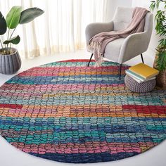 a multicolored rug with a chair and potted plant