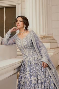 Pakistani Bridal Dress in Ice Blue Pishwas Frock Style is a magnificent attire that will give the gorgeous bride a head-turning look on the big day. Intricate designs and hand-crafted embellishments make this Pakistani Bridal Outfit an epitome of beauty and grace. Pishwas Frock: This Pishwas Frock in an alluring ice blue shade is embellished with lavish embroidery, sequins, pearls, crystals, and motifs, giving a glamorous touch to the Pishwas Dress. The graceful intricate design, shimmering silverwork, and perfect stitching of this Pakistani Bridal Pishwas in net fabric make it a perfect choice to have a dreamy elegant look. Bridal Lehenga is prepared on customized orders to pair with the embellished Pakistani Bridal Pishwas. Net Dupatta: ﻿The Latest Pakistani Bridal Dress in Pishwas style Blue Pakistani Bridal Dress, Pakistani Lehenga, Canada Clothes, Pakistani Bridal Dress, Yumna Zaidi, Australia Clothes, Frock Style, Pakistani Couture, Bridal Dresses Pakistan