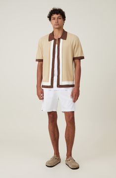 Cool is the calling card of this short-sleeve button-up shirt knit in an easygoing silhouette with cable knit contrasting trim. Front button closure Spread collar Short sleeves 100% cotton Machine wash, line dry Imported Summer Polo Shirt With Contrast Collar And Short Sleeves, Casual Summer Tops With Contrast Collar, Summer Knit Polo Shirt With Collared Neckline, Casual Beige Polo Shirt With Button Closure, Summer Tops With Contrast Collar And Short Sleeves, Casual Collared Polo Shirt With Contrast Trim, Spring Casual Polo Shirt With Contrast Collar, Knit Short Sleeve Polo Shirt For Summer, Collared Tops With Contrast Trim For Summer