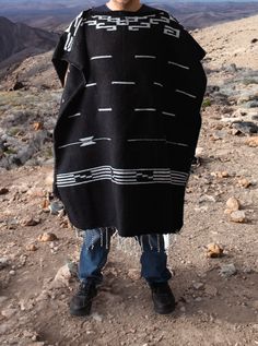 Material: Acrylic WoolColor: BlackStyle: Mexican Design: Clint EaswoodSize:Length: 192cm (75")Width: 112 cm (44")It refers to the total measurements of the poncho when it is fully open (like a blanket). Description: MEXICAN PONCHO Discover the iconic Mexican Poncho Clint Eastwood made famous. This timeless garment has been a symbol of rugged style and effortless cool. Crafted with authentic Mexican craftsmanship, our Mexican Poncho captures the essence of Clint Eastwood's classic western films. Black Beach Poncho One Size, Black One Size Poncho For Beach, Black One Size Beach Poncho, Black Long Sleeve Poncho For Beach, Black Long Sleeve Beach Poncho, Oversized Black Outerwear For The Beach, Black Long Outerwear For Festivals, Long Black Outerwear For Festival, One Size Black Cape For Festival