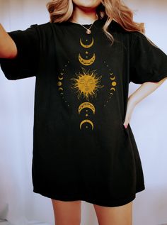 "Celestial Moon Shirt, Boho Sun Shirt, Comfort Colors® Shirt, Astrology Shirt, Spiritual Shirt, Mystical Shirt, Celestial Shirt, Witchy Shirt WELCOME TO BUTIKCHI  This is a standard unisex size Comfort Colors Tee. For an oversized tee, please size up. Please review the size chart to ensure you receive the fit you want. How to Order?  Please, choose your favorite color and size from the pop-up window. Select the quantity that you want. Click \"ADD TO CART\". You can go back to add more product color for your loved ones members.  You can complete the checkout process. Please \"Click Proceed to Check Out\" Finally, you have completed all the steps, your product will be prepared to be shipped. Washing Care Instructors Use cold water when washing, do not use bleach, do not dry clean, and do not Graphic Tee Shirt With Moon Print, Bohemian Short Sleeve T-shirt With Sun And Moon Design, Black Bohemian Relaxed Fit Shirt, Bohemian Cotton T-shirt With Sun And Moon Design, Celestial Cotton Tops For Summer, Relaxed Fit Graphic Tee With Moon Print, Relaxed Fit Moon Print Graphic Tee, Summer Moon Print Relaxed Fit Shirt, Black Short Sleeve Shirt With Moon Print