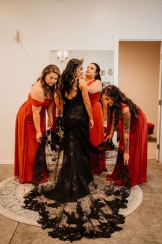 the bridesmaids are dressed in red and black