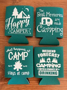 four camper can coolers on a table with the words happy camper printed on them