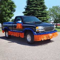 a black truck with orange and blue decorations on it