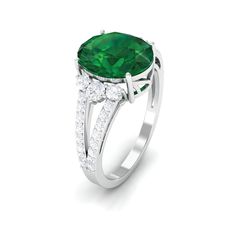 Product Details The timeless elegance of this Emerald Engagement Ring is sure to make your moment memorable. Features 8X10 mm oval-shaped created emerald artfully set in prong setting complimented by round petite moissanite, adding an extra hint of sparkle to the emerald ring. Take her breath away with this green emerald ring crafted with a split shank that embraces the overall brilliance of the engagement ring. This stunning split shank ring carries a weight of 4 carats. Celebrate special momen Emerald Solitaire Engagement Ring, Split Shank Engagement Ring, Shank Engagement Ring, Split Shank Engagement Rings, Green Emerald Ring, Split Shank Ring, Lab Created Emerald, Ring Crafts, Split Shank