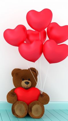 a brown teddy bear holding red heart shaped balloons