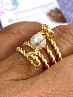 "Beautiful and unique Pearl Gold Wire Wrapped Ring, ideal for an special gift for her, it's very elegant and will make her get many compliments.  This ring is made with a 6mm round pearl and wrapped in non tarnish gold wire. It is made to order in the size of your choice.  I T E M ~D E T A I L S Materials: Gold Plated Twisted Wire, Swarovski 6mm Pearls. Size: See Variations. Thank you for visiting my product. You can see more amazing designs in my shop clicking here: https://www.etsy.com/shop/Na Handmade Gold Pearl Promise Ring, Adjustable Gold Pearl Promise Ring, Elegant Hand Wrapped Rings For Anniversary, Elegant Adjustable Hand-wrapped Rings, Elegant Wire Wrapped Toe Rings, Elegant Wire Wrapped Promise Ring, Gold Pearl Rings As A Gift, Gold Pearl Toe Ring As Gift, Elegant Gold Hand Wrapped Rings