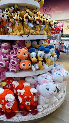 there are many stuffed animals on display in the store