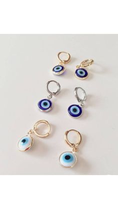 Turkish eye jewelry is a perfect evil eye gift choice on Christmas, birthday, Mother's day or Valentine's day. Nazar earring which offers good luck and protection is great for daily wear. Evil eye hoop earrings are tarnish resistant. These huggie earrings with charms are great for daily wear. These lucky eye earrings are classy to fit evey outfit. Lenght of the dainty evil eye earring is 3 cm (1.18 in) Lenght of the evil eye drop is 1 cm (0.39 in) For more evil eye earrings, click the link below Gold Evil Eye Earrings As Gift, Elegant Evil Eye Earrings As A Gift, Elegant Evil Eye Earrings For Gift, Eye-catching Dangle Jewelry For Gifts, Eye-catching Evil Eye Jewelry For Gift, Evil Eye Round Earrings For Gift, White Evil Eye Dangle Jewelry, Party Dangle Evil Eye Jewelry, Silver Round Evil Eye Earrings