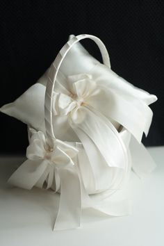 a white basket filled with flowers on top of a table