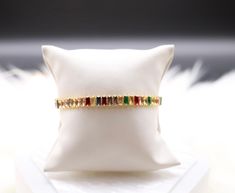 The Rainbow Colored Baguette Tennis Bracelet is a vibrant and captivating accessory adorned with a spectrum of baguette-cut gemstones, creating a stunning visual display of colors. This bracelet adds a playful and joyful touch to your ensemble, making it a lively and fashionable piece for various occasions. Elegant Multicolor Rectangular Bracelet, Elegant Rainbow Bracelets For Parties, Visual Display, Baguette Cut, Tennis Bracelet, Christmas Sale, The Rainbow, Rainbow Colors, Baguette