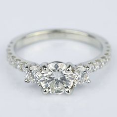 three stone engagement ring with diamond shoulders