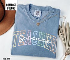 Celebrate the wonders of science with our Comfort Colors t-shirt for science teachers! Available in Blue Jean, Light Green, Berry, and Pepper, this soft and comfy tee features a relaxed fit ideal for any classroom. It makes a fantastic gift for Teacher Appreciation Week, birthdays, or end-of-year celebrations, honoring the enthusiasm and dedication of science educators. Wear it with pride and inspire curiosity in the next generation of scientists! Comfort Colors T shirt Details: 100% ring-spun c Reading Tshirt, Science Teacher Shirt, Math Teacher Shirts, Teaching Shirts, Music Teacher Gifts, Great Teacher Gifts, Teacher Tees, Teacher Appreciation Week, Gift For Teacher