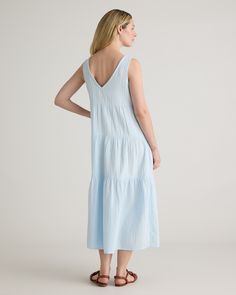 The ultimate slip on and step out style, this easy-to-wear dress still packs a fashionable punch. Made of breezy, lightweight organic cotton gauze, it features a v-neck in the front and back and flowy tiered bodice. Slide into a pair of sandals and top with a few pieces of jewelry and you’ve got a full look.  | Quince | Women's Gauze Tiered Maxi Dress in Nantucket Blue, Size Large, Organic Cotton Breezy V-neck Loungewear Dress, Breezy Spring Maxi Dress For Loungewear, Breezy Maxi Dress For Spring Loungewear, Breezy Spring Loungewear Maxi Dress, Cotton V-neck Unlined Maxi Dress, Breezy Spring Loungewear Dresses, Breezy Linen V-neck Dress, Gauze Maxi Dress, Wide Leg Linen Pants