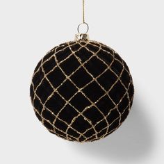 a black and gold ball ornament hanging from a chain