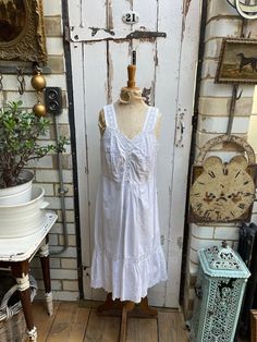 Antique French white cotton slip dress with lace top and hem size S. 100% Cotton. Shift dress with soft v-shaped neck, lace shoulder straps, embroidered top section, button thro to waist, then skirt with lace panel and embroidery at hem - lovely. Size:  Chest: 34 inches; Waist: 34 inches; Length: 43 inches. Weight: allow up to 1 kg once packed. Good condition. Summer Cotton Dresses With Delicate Lace, Cottagecore Sleeveless Dress With Lace Trim, Cotton V-neck Dress With Lace Patchwork, Fitted Cotton Dress With Delicate Lace, Cottagecore V-neck Dress With Lace Trim, Sleeveless Daywear Dress With Delicate Lace, Sleeveless Dress With Delicate Lace For Daywear, White Cotton Camisole Dress, Camisole Dress With Lace Trim For Daywear