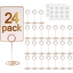 a pack of 24 gold number tags with pins