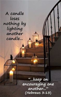 some lit candles sitting on the steps in front of a stair case with a quote