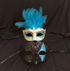 This unique couple's masquerade masks are great for any Venetian mask party or masquerade ball. The women's mask is made of a lightweight non bendable polyvinyl and is hand painted in a two-tone aqua, gold and white with glitter accents. The men's mask is made of a lightweight metal and hand painted with aqua color diamond.  Both masks have some flex and come with black silk ribbon ties attached. Women's mask fit size 6"W x 4.5"H. Men's mask size 7"W x 4.25"H. Painted Masquerade Mask, White With Glitter, Couples Masquerade Masks, Venetian Masquerade Masks, Feather Mask, Bird Masks, Female Mask, Venetian Masquerade, Mask Masquerade