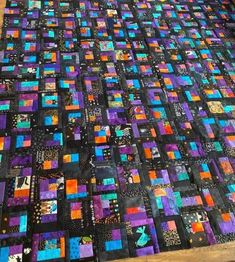 a very large quilt made with many different colored blocks