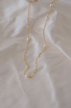 An effortless piece that's perfect for everything. Pearls are believed to be a calming, centering gem that nourishes integrity, faith, and loyalty. They are also symbols of femininity, helping one connect with their inner goddess or feminine energy.This necklace features alternating small and medium pearls that are hand-set onto a shimmering chain. The pearls are slightly irregular in shape and may contain natural natural grooves. Chains are available in sterling silver or 14k gold filled.PEARL Adjustable Gold Pearl Chain Jewelry, Graceful Gold Necklace With Pearl Charm, Feminine Gold Necklace With Pearl Charm, Everyday Gold Feminine Pearl Necklace, Gold Pearl Necklace For Everyday Feminine Style, Feminine Everyday Gold Pearl Necklace, Everyday Feminine Gold Pearl Necklace, Graceful Gold Necklace With Pearl Chain, Graceful Gold Pearl Chain Jewelry