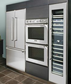 an oven and refrigerator in a kitchen with tile flooring