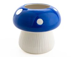 a blue and white mushroom shaped vase sitting on top of a table