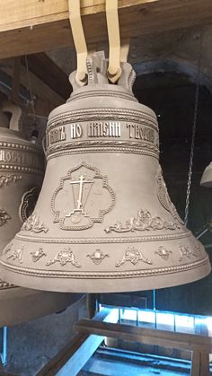 two bells hanging from the ceiling in a building