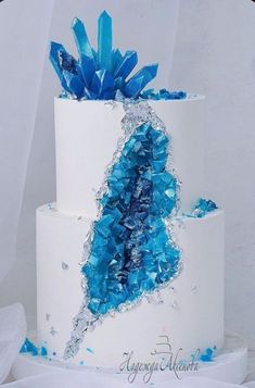 a white cake with blue decorations on top