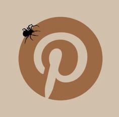 a black spider sitting on top of a pin logo