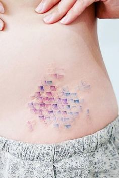 a woman's stomach with small squares on it