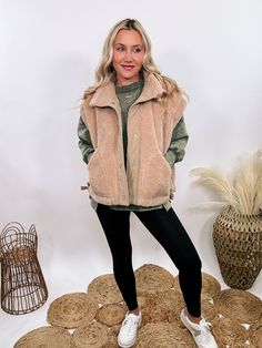 Tan Camel Sherpa Vest with Side Ties Stay warm and stylish all season long with our Tan Camel Sherpa Vest. This cozy piece features side ties, pockets, and a button-up front, giving you a chic, functional look perfect for layering. The oversized cut creates a subtle cap sleeve effect, adding a unique touch to your cold-weather outfits. With its soft sherpa composition, this vest will keep you snug on casual outings, outdoor adventures, or cozy nights by the fire. Whether you're layering it over a sweater for a day at the pumpkin patch or pairing it with a long-sleeve tee for running errands, this medium-to-heavy weight vest is a fall and winter essential. Style it with jeans and boots for an effortlessly chic look or give a casual street style vibe by layering it over our acid washed pullo Sherpa Vest Outfit, Weight Vest, Weighted Vest, Weather Outfits, Sherpa Vest, Long Vests, Cold Weather Outfits, Graphic Tops, Vest Outfits