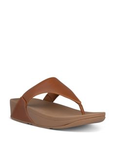 FitFlop Women's Lulu Slip On Thong Wedge Sandals Brown Toe Post Wedge Sandals, Adjustable Toe Post Leather Wedge Sandals, Adjustable Leather Toe Post Wedge Sandals, Summer Leather Wedge Heel Flip Flops, Beach Wedge Sandals With Heel And Toe Loops, Leather Wedge Heel Flip Flops For Summer, Adjustable Toe Post Wedge Sandals With Arch Support, Leather Flip Flops With Wedge Heel For Summer, Brown T-strap Wedge Sandals For The Beach