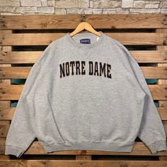 Vintage Notre Dame Fighting Irish Sweatshirt Notre Dame Pullover Sweater Notre Dame Crewneck Jumper Notre Dame Embroidery Logo Grey Color Brand Name :- Champs  📌 Tag Size :-  2XLarge 📌 Recommend Size :- 3XLarge Manual Measurement :- WIDTH (armpit to armpit) :- 29 inches / 73cm LENGTH (shoulder to end of garment) :- 27 inches / 69cm Condition :- Good Condition 9/10.  Refer Picture. 📮FED EX / DHL EXPRESS = 3-6 business day arrived Embroidered Long Sleeve College Sweater, Embroidered Long Sleeve Sweater For College, Gray Long Sleeve Top With Letter Embroidery, College Crew Neck Sweater With Embroidered Graphics, Vintage College Sweatshirt With Embroidered Text, Collegiate Winter Tops With Embroidered Text, Collegiate Style Winter Top With Embroidered Text, College Crew Neck Sweater With Letter Embroidery, Gray College Tops With Embroidered Logo