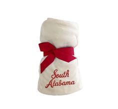 a white towel with a red ribbon around it and the words south alabama on it