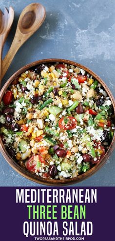 mediterranean bean quinoa salad in a bowl with wooden spoons on the side