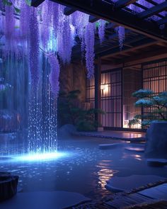 an indoor fountain with purple flowers hanging from it's sides and water running down the side