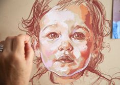 a drawing of a child's face is being drawn by someone using colored pencils