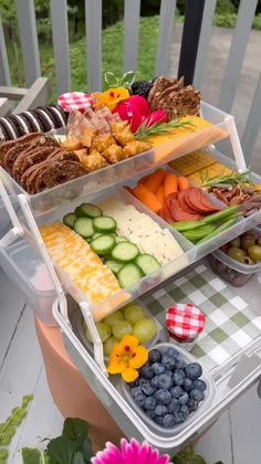 three tiered trays filled with different types of food on top of a table