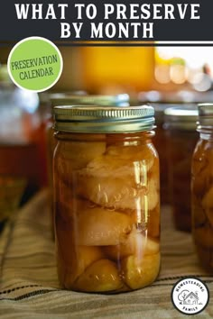 two jars filled with pickles sitting on top of a table next to each other