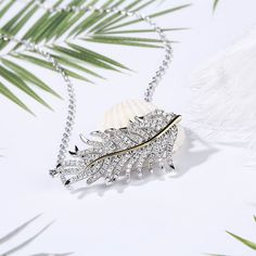 This neckalce is inspired by the floating feather which signify freedom and beauty. Using the shinning stones to decorate the feather makes the perfect balance between elegant and beauty. Carat Weight: 1.153 ctStone Size: 1.2,1.1,0.9 mmStone Type: Jeulia® StoneNumber of Stones: 132 Stone Shape: RoundStone Color: Diamond WhiteChain Type: Cable chainWeight: 5.36 gWidth: 34.3 mmHeight: 16.6 mmThickness: 6.35 mmMaterial: 925 SilverPlating Color: Silver, Yellow Gold Elegant Feather Jewelry As Gift, Elegant Feather Jewelry Gift, Elegant Feather Jewelry For Gift, Floating Feather, Cross Chain, White Necklace, Necklace Online, Sterling Silver Necklace, Quality Jewelry