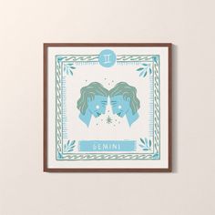 two women's heads in blue and green framed artwork on a white wall with the words genni above them