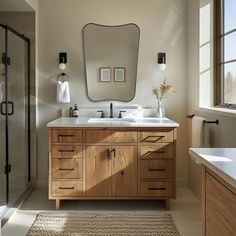 a bathroom with two sinks and a large mirror on the wall next to a walk in shower