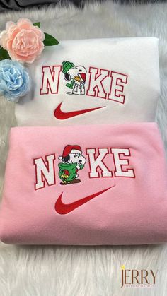 two pink and white towels with the word nike on them, one has a cartoon character