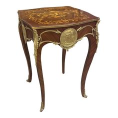 an ornately decorated wooden table with gold trimmings on the top and sides