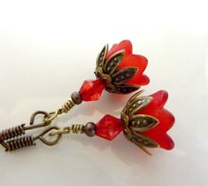 "BRIDESMAIDS EARRINGS red earrings flower vintage style red bell flower wedding bridal jewelry Beautiful bridesmaids earrings, gorgeous petite red bell flower vintage style earrings are available. Hanging from vintage style brass fish hooks, these lovely petite red bell flowers are encased by sweet vintage brass leaf bead caps, finished with red crystal bicone beads. This listing is for 1 pair, but you can buy more for the beautiful bridesmaids. These earrings measure a little more than 1 1/4\" Red Flower Drop Earrings For Wedding, Red Flower Earrings For Wedding, Red Drop Earrings With Flower Charm, Red Flower Shaped Wedding Earrings, Red Flower-shaped Wedding Earrings, Vintage Red Flower Shaped Jewelry, Vintage Red Flower Earrings For Gift, Handmade Vintage Red Flower Earrings, Vintage Handmade Red Flower Earrings