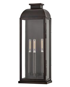 an outdoor light fixture with three lights on the front and back sides, in dark bronze