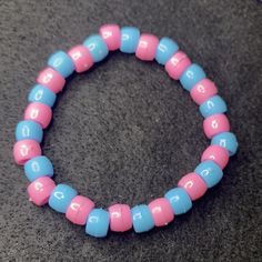 Material: Clear string Color: Pink and blue beads Type: Bracelet Style: Casual Blue Bangle Jewelry With Large Beads, Handmade Light Blue Beaded Bracelets, Pink Bohemian Stretch Bracelet With Round Beads, Blue Bracelets With Large Round Beads, Blue Friendship Bracelet With Colorful Round Beads, Bohemian Pink Stretch Bracelet With Round Beads, Pink Bracelets With Colorful Beads For Friendship, Pink Bohemian Bracelets With Spacer Beads, Pink Beaded Bangle Jewelry