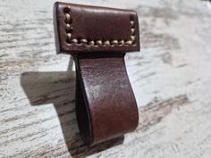 a close up of a leather belt on a table